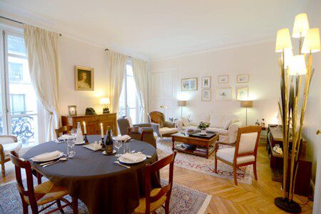 Luxury apartment near Champs-Élysées Paris – dining area set for four with floor lamp