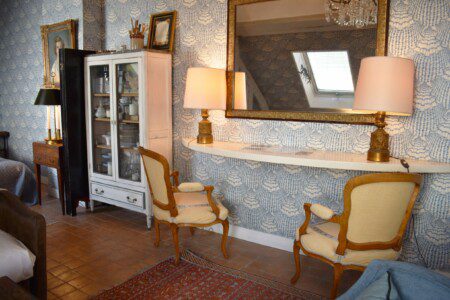 Luxury studio Rue Saint-Honoré Paris 1st – Stylish living room with blue damask wallpaper and gilded mirror