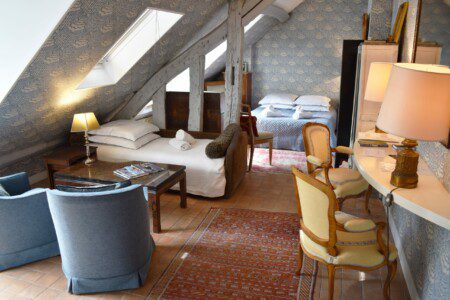 Luxury studio Rue Saint-Honoré Paris 1st – living room with daybed and double bed under exposed beams