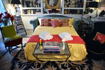 Luxury family apartment near Eiffel Tower Paris – sitting room with green velvet sofa bed and portrait