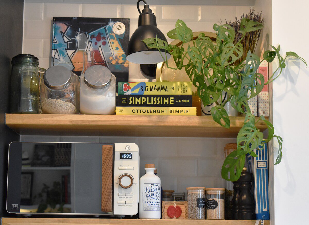 Luxury apartment near Parc Monceau Paris – kitchen shelf with cookbooks plants and jars