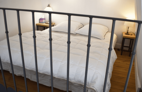 Artist loft Paris – big bed in mezzanine bedroom