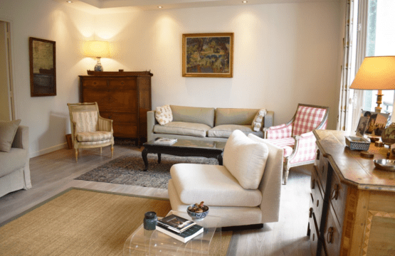 Luxury apartment near Luxembourg Garden Paris – lounge with sage sofa and checked armchairs