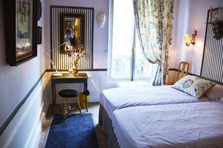 Luxury duplex near Eiffel Tower Paris – bedroom with striped mirror and floral curtains